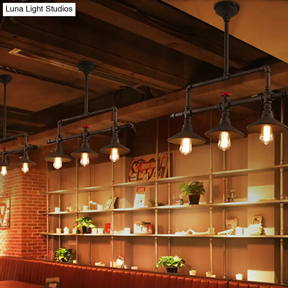 Industrial bronze pipe island light with five black pipe pendant lights and exposed filament bulbs for dining room use