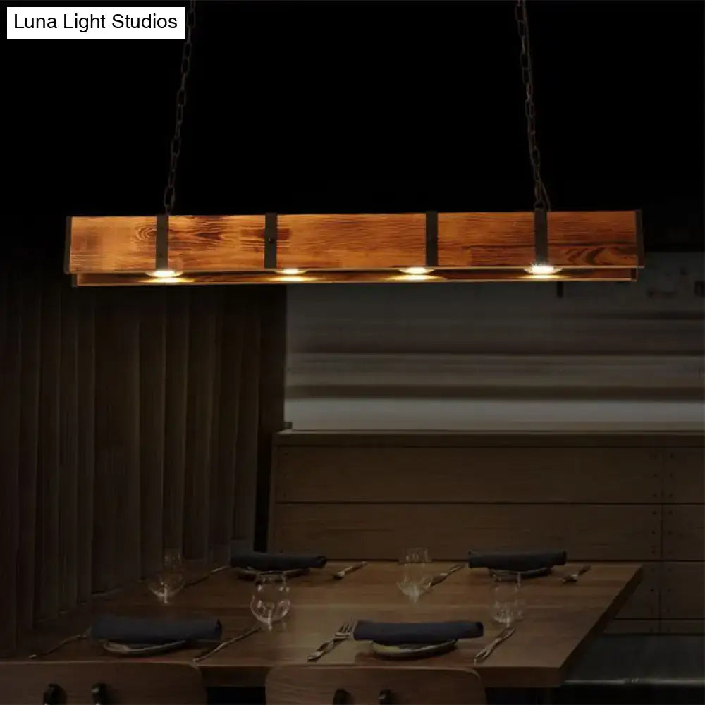 Rustic rectangular wooden island ceiling light with black metal accents and warm glowing bulbs for kitchen use