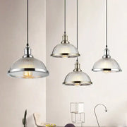 Industrial brushed nickel pendant light with ribbed glass shade designed for dining room use