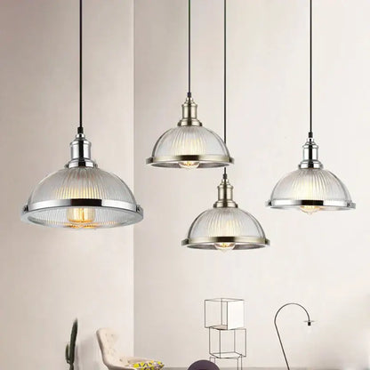 Industrial brushed nickel pendant light with ribbed glass shade designed for dining room use
