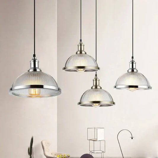 Industrial brushed nickel pendant light with ribbed glass shade designed for dining room use