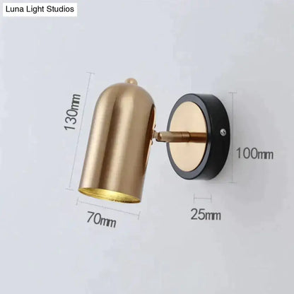 Gold-toned industrial led wall sconce with sleek finish black base and adjustable arm for bedroom spotlight lighting