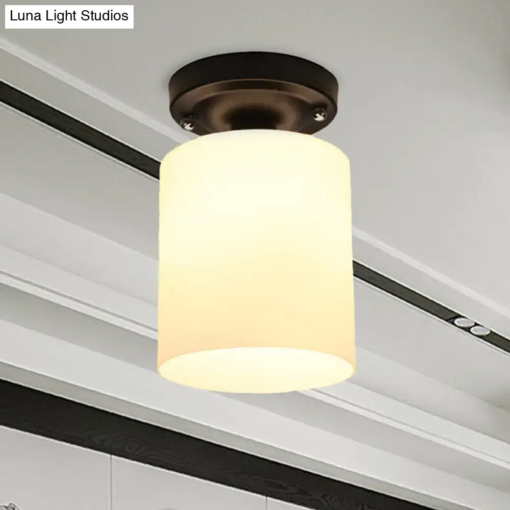 Decorbites black industrial milky glass semi flush light with warm-toned cylindrical glass shade and dark bronze ceiling mount
