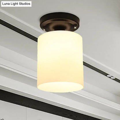 Decorbites black industrial milky glass semi flush light with warm-toned cylindrical glass shade and dark bronze ceiling mount