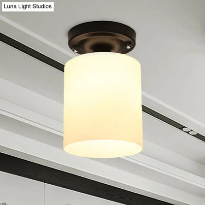 Decorbites black industrial milky glass semi flush light with warm-toned cylindrical glass shade and dark bronze ceiling mount