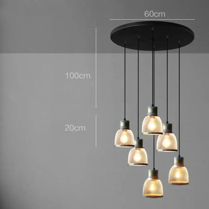 Black circular industrial cement metal pendant light with five warm-toned glass shades and brass accents for dining room decorbites industrial cement