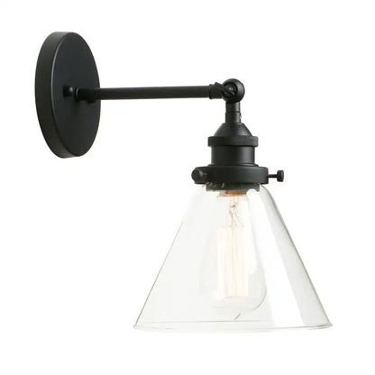 Black wrought iron wall sconce with clear glass shade and exposed Edison bulb for industrial bedroom light fixture