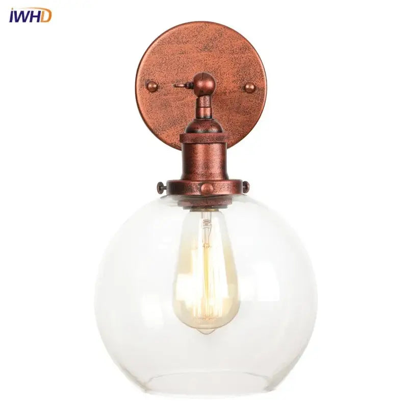 Copper-finished industrial wall sconce with clear decorbites glass globe housing a glass globe led bulb for bedroom light