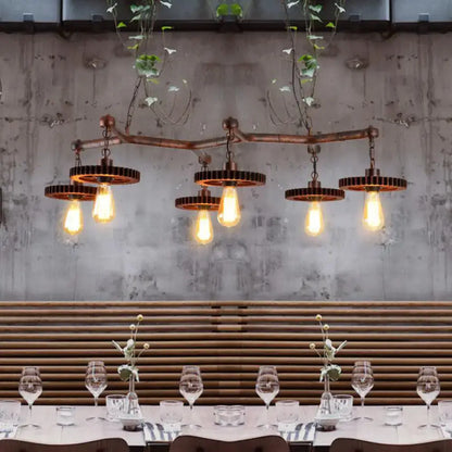 Industrial copper metal island lamp with five exposed edison bulbs and gear-shaped metal shades for dining room use