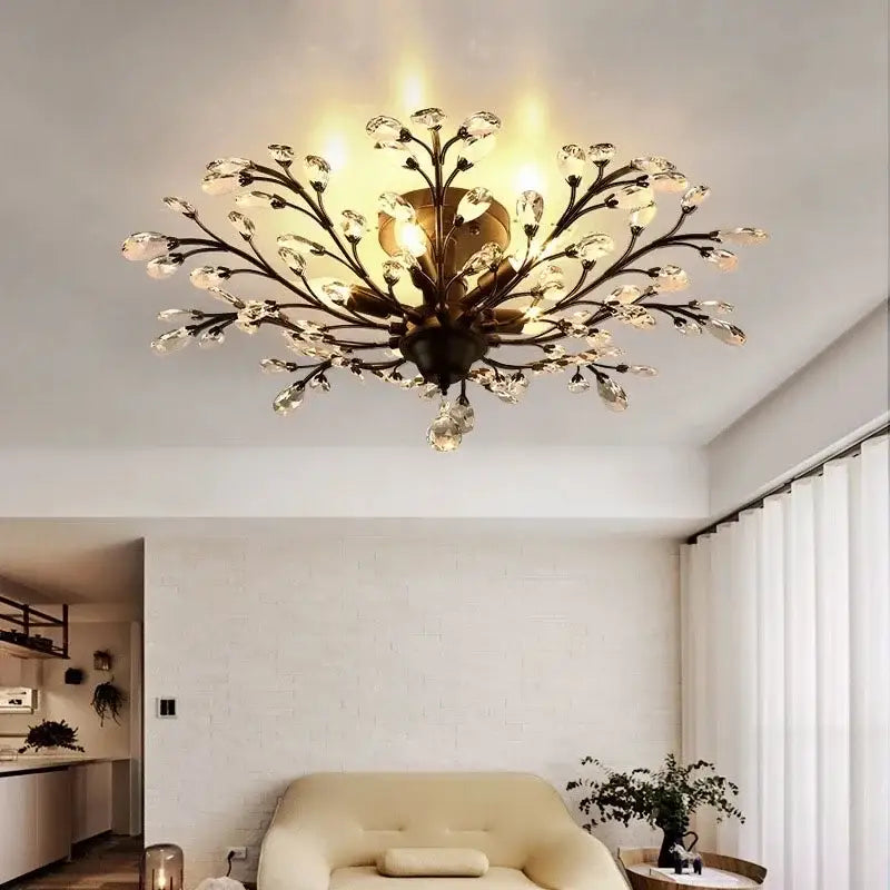 Golden-toned industrial crystal chandelier with antique bronze branch arms and clear teardrop crystal droplets decorbites industrial