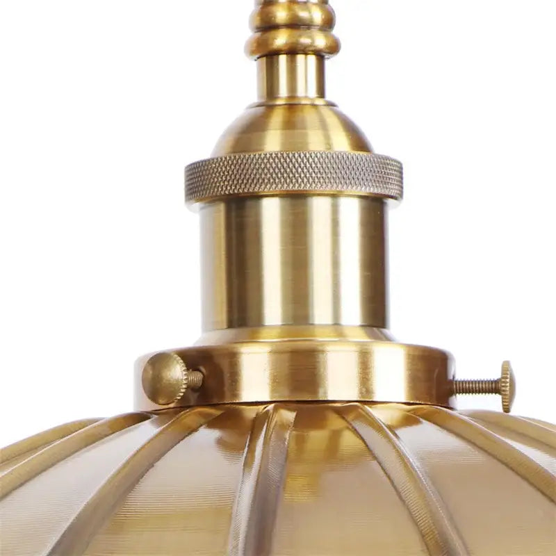 Industrial gold fluted wall lamp with brass finish and pull chain switch featuring a textured knurled ring shade