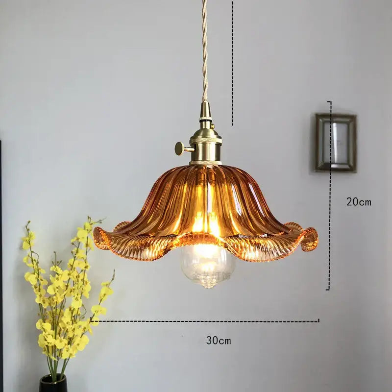 Amber-colored hand-blown glass industrial pendant light with brass fixture and twisted cord for dining room decorbites glass industrial