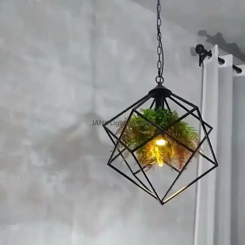 Black metal geometric pendant light with hanging chain and greenery inside by Decorbites industrial greenery chandelier