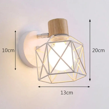A modern industrial iron cage wall light with a silver metal frame, white base, and natural wood cap by decorbites