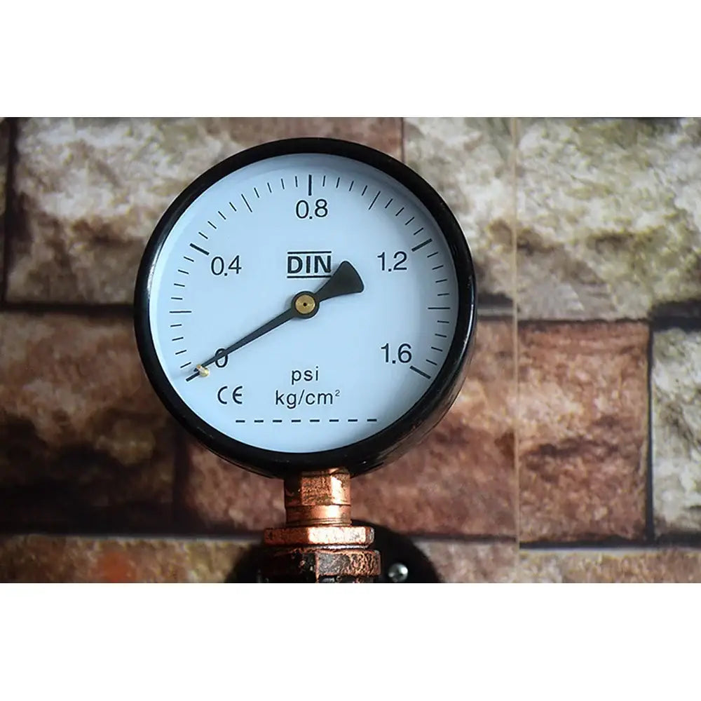 Black-rimmed pressure gauge with white face and din label on decorbites industrial iron rust wall light sconce