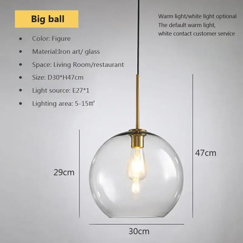 A clear glass globe pendant light with brass-finished iron art fixture and exposed bulb by decorbites industrial loft