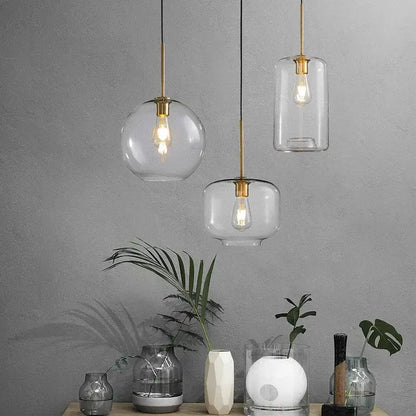 Three industrial loft glass pendant lights with brass accents and clear or frosted shades for dining room decorbites industrial loft