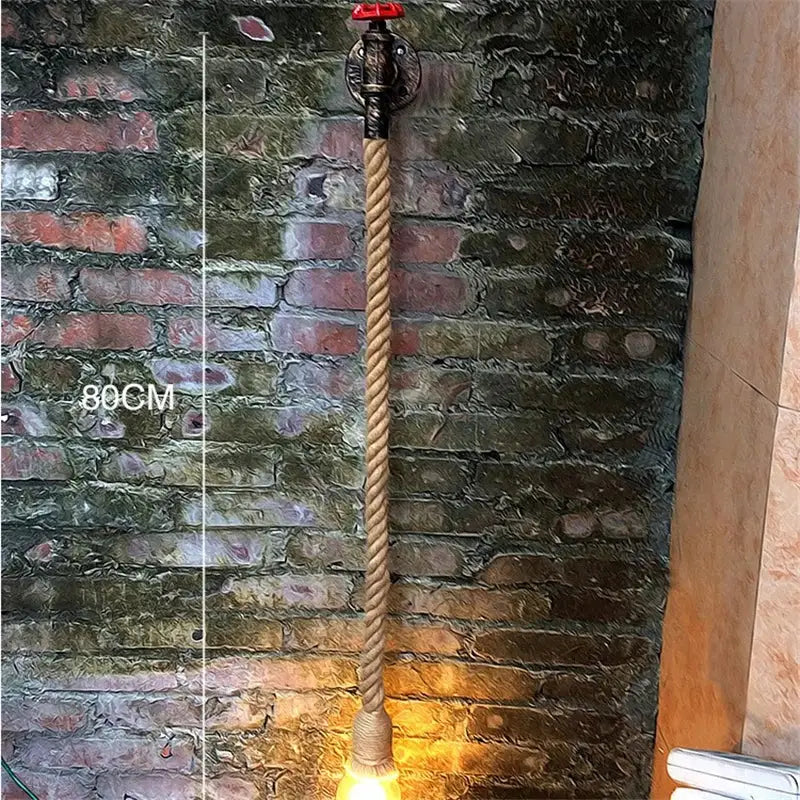 Industrial loft hemp rope wall lamp featuring a natural fiber rope and ornate metal pipe valve with a red handle decorbites