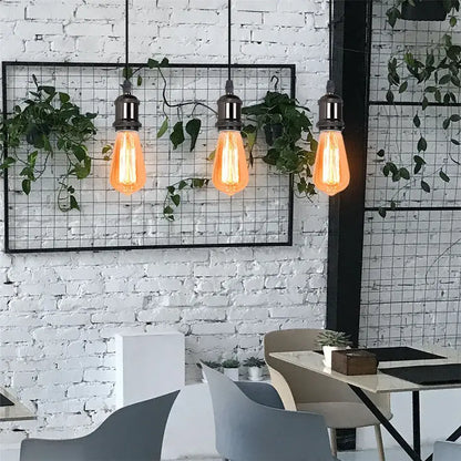 Three hanging edison-style bulbs with warm glow in decorbites industrial loft led black and brass pendant light