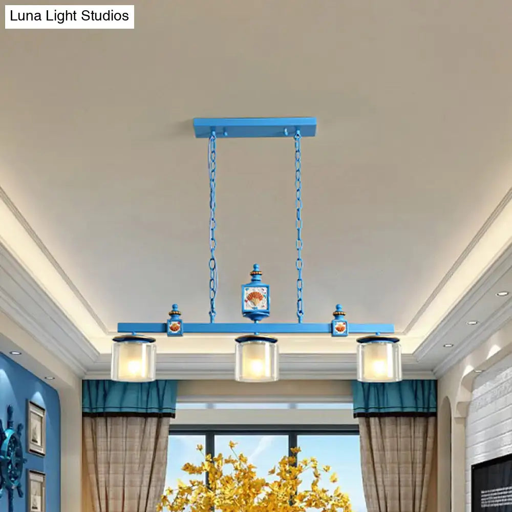 Blue rectangular chandelier with three glass shades and shell motifs in a decorbites light blue dual cylinder parlor lamp