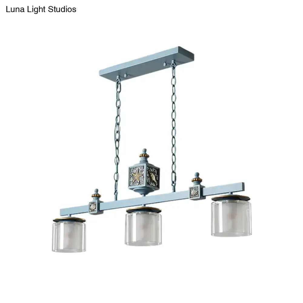 Antique-style light blue dual cylinder parlor island pendant lamp with three clear glass shades and ornate metal details