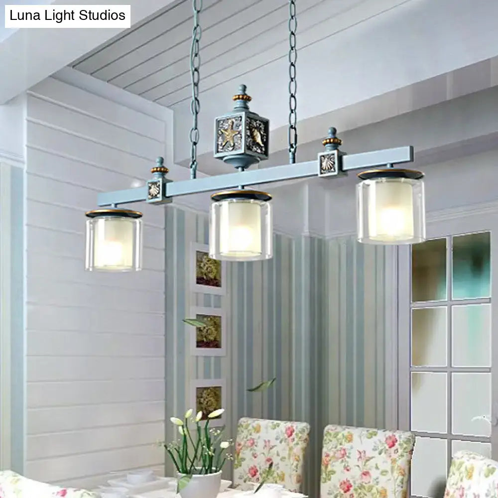 Antique-style teal metal chandelier with three clear glass shades featuring ornate details for dual cylinder parlor use