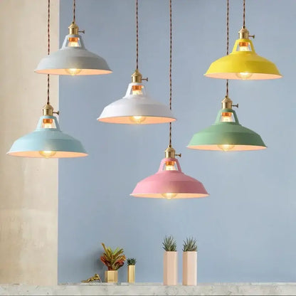 Industrial pastel metal pendant light with brass hardware and exposed bulbs featuring a metal finish shade