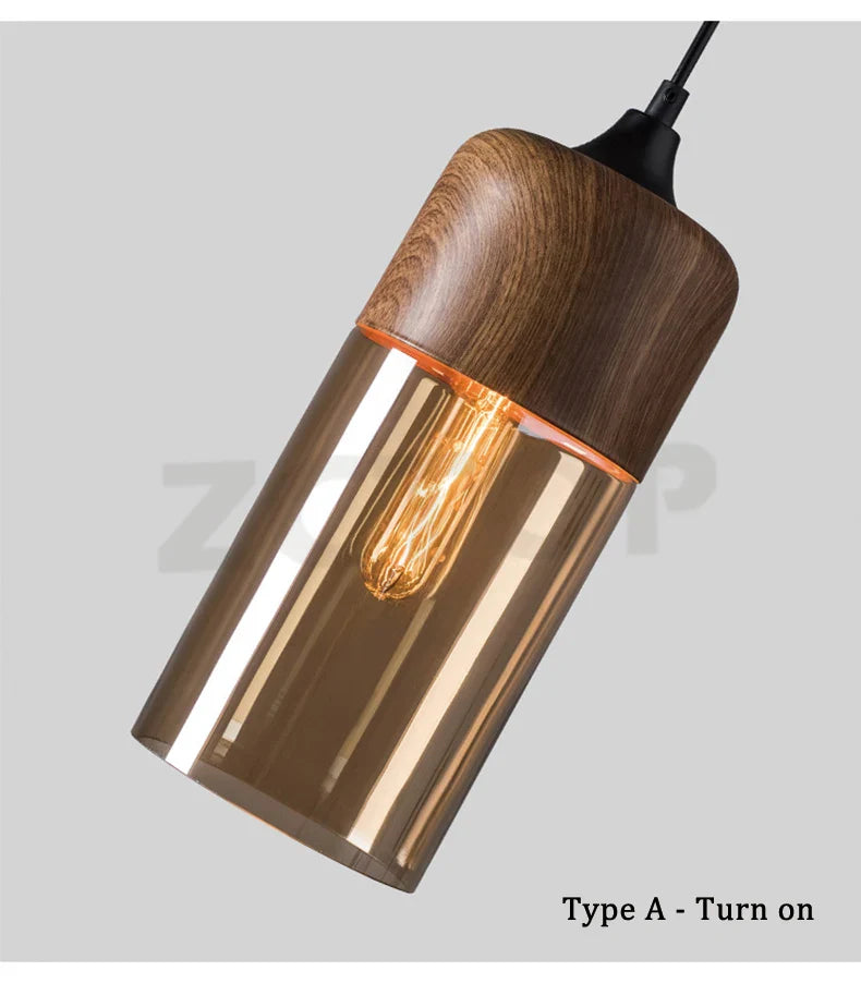 Warm-toned glass led pendant light with dark wood top and exposed filament bulb for dining room light source