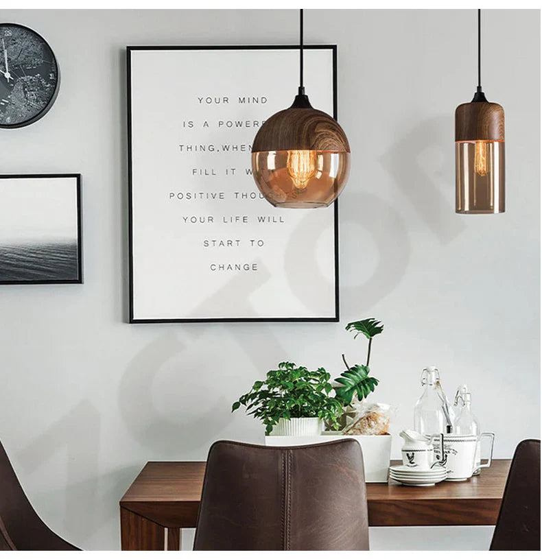 Copper-toned spherical led pendant light with wooden top and visible filament bulb as a dining room light source
