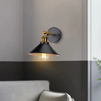 Black metal wall sconce with brass accents and conical shade decorbites industrial retro loft bedroom lighting