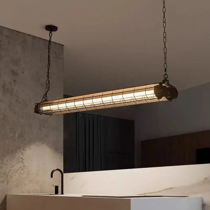 Industrial retro polished chrome pendant light with cylindrical glass tube and metal cage suspended by dark chains