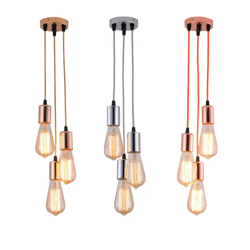 Three modern industrial rose gold and chrome led pendant lamps with exposed filament bulbs for dining room lighting