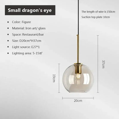 A modern industrial glass pendant light with smoked clear globe and brass accents for dining room decorbites industrial glass