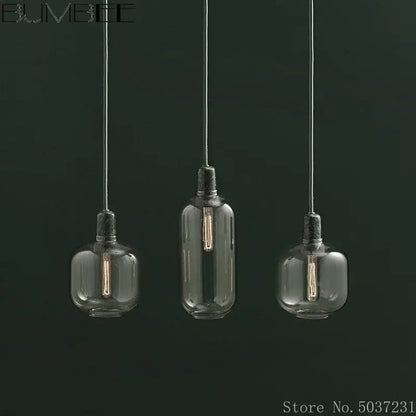 Industrial stained glass pendant light set with three frosted clear filament bulbs hanging by black cords for dining room decorbites industrial stained