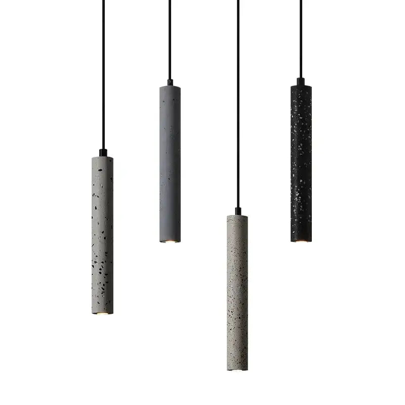 Four minimalist cylindrical pendant lamps with textured speckled concrete finish in gray and black by decorbites industrial stone led