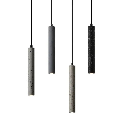 Four minimalist cylindrical pendant lamps with textured speckled concrete finish in gray and black by decorbites industrial stone led