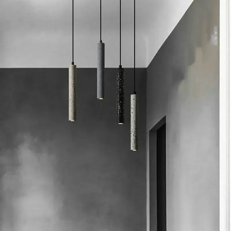 Four industrial stone led pendant lamps with beige gray black and off-white speckled concrete finish by decorbites