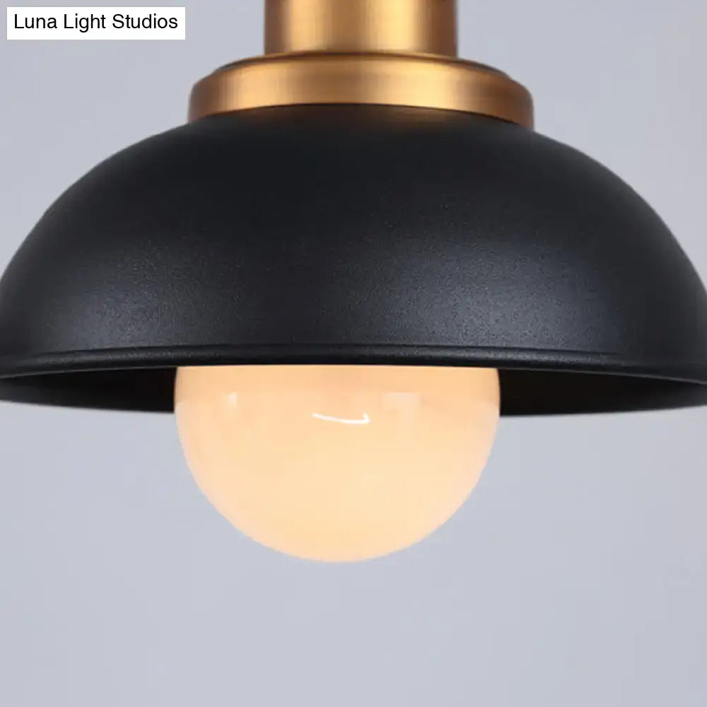 Black matte dome pendant light fixture with brass-toned metal and exposed warm-white bulb industrial style ceiling light