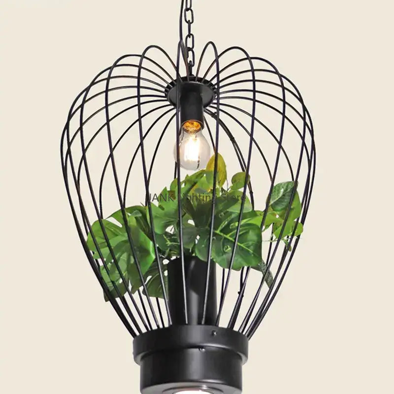 Black metal wire cage pendant lamp with hanging bulb and green plant for industrial style planting decorbites decor