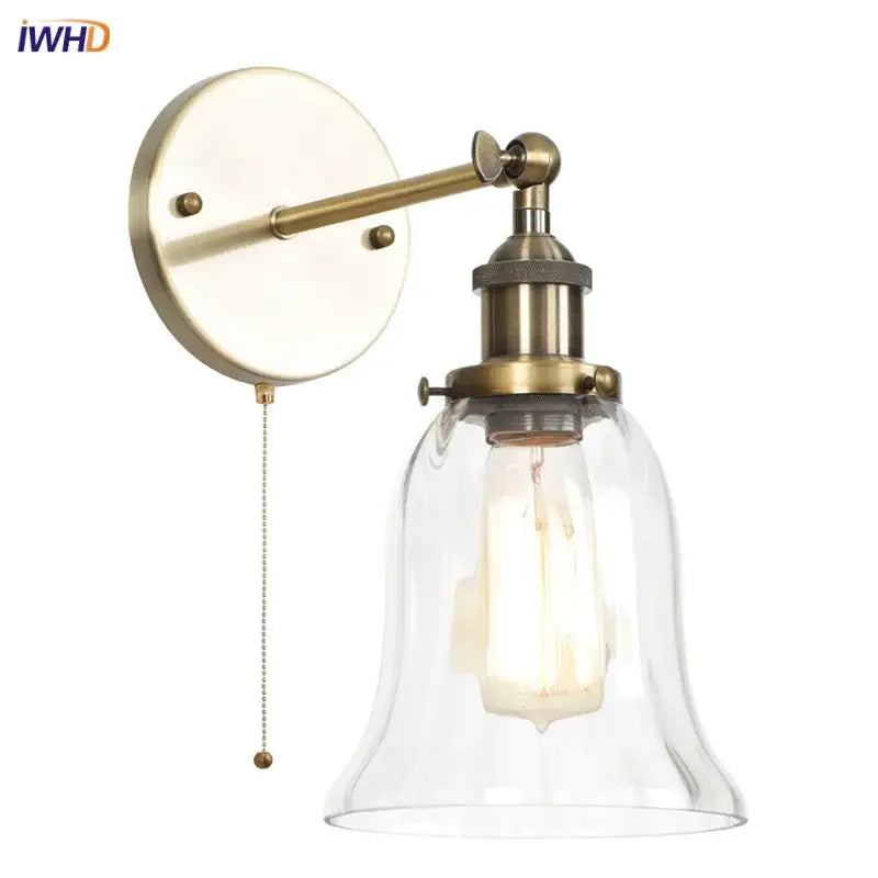 Antique brass wall sconce with clear glass bell shade and exposed Edison bulb for decorbites industrial vintage bedroom decor