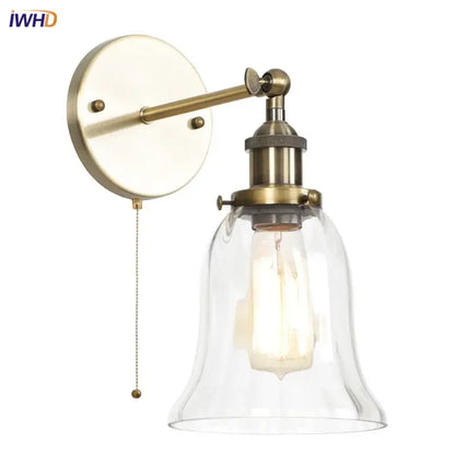 Antique brass wall sconce with clear glass bell shade and exposed Edison bulb for decorbites industrial vintage bedroom decor