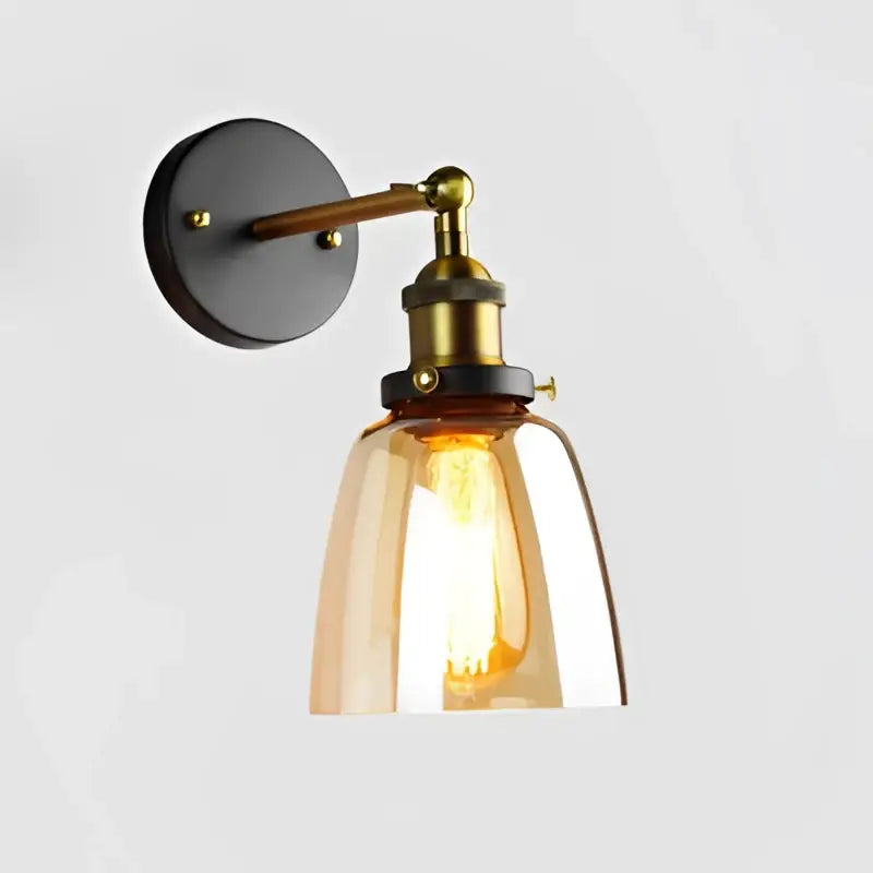 Industrial vintage black and brass wall sconce with amber glass shade and exposed filament bulb for decorbites industrial vintage loft decor