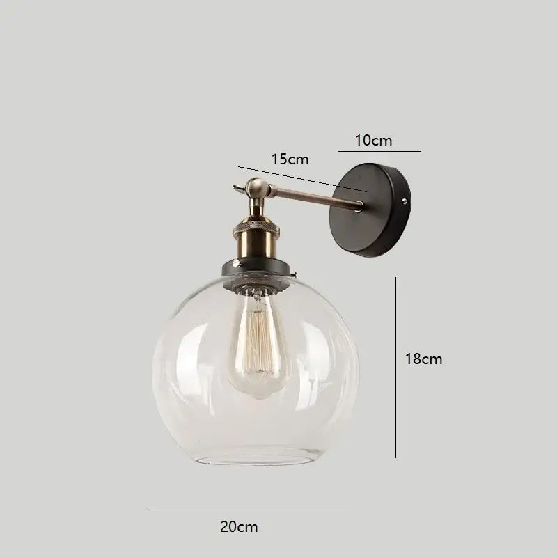Industrial vintage black and brass wall sconce with clear glass globe and exposed filament bulb for decorbites industrial vintage loft decor