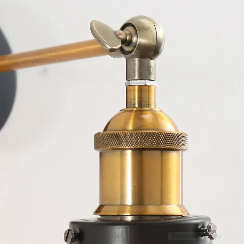 Brass-finished industrial vintage loft wall sconce with textured knurled collar and adjustable arm for bedroom decorbites lighting