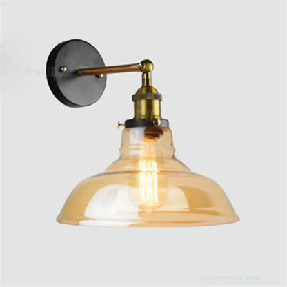 Industrial vintage black and brass wall sconce with amber glass shade and exposed filament bulb for decorbites industrial vintage loft decor