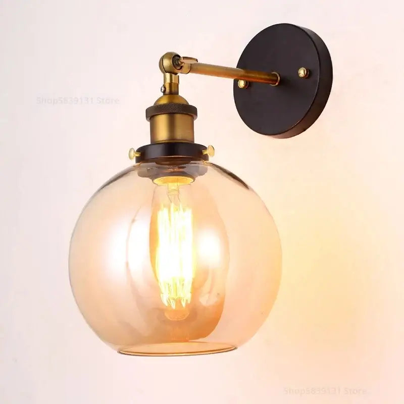 Industrial vintage black and brass wall sconce with warm amber glass globe for decorbites industrial vintage loft lighting