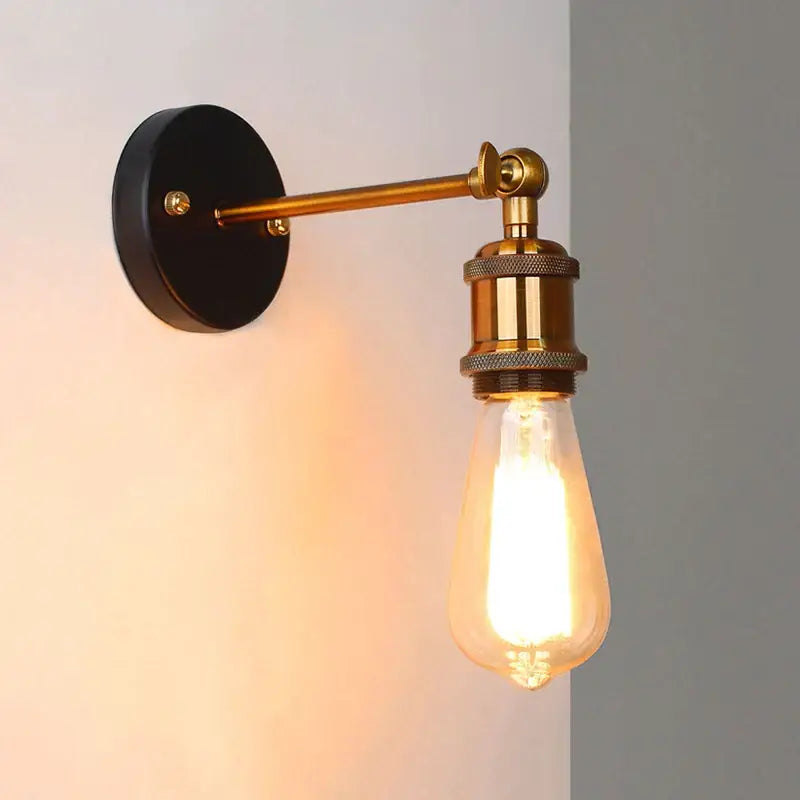 Vintage-style brass wall sconce with black base and exposed Edison bulb for decorbites industrial vintage loft decor