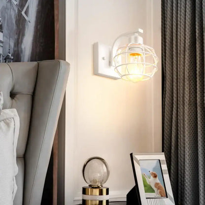White iron cage wall light with warm glowing bulb for decorbites industrial vintage bedroom sconce lighting