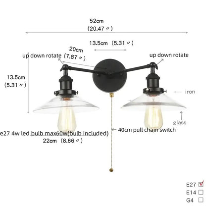 Black iron industrial vintage wall lamp with two adjustable arms and clear glass shades featuring Edison bulbs