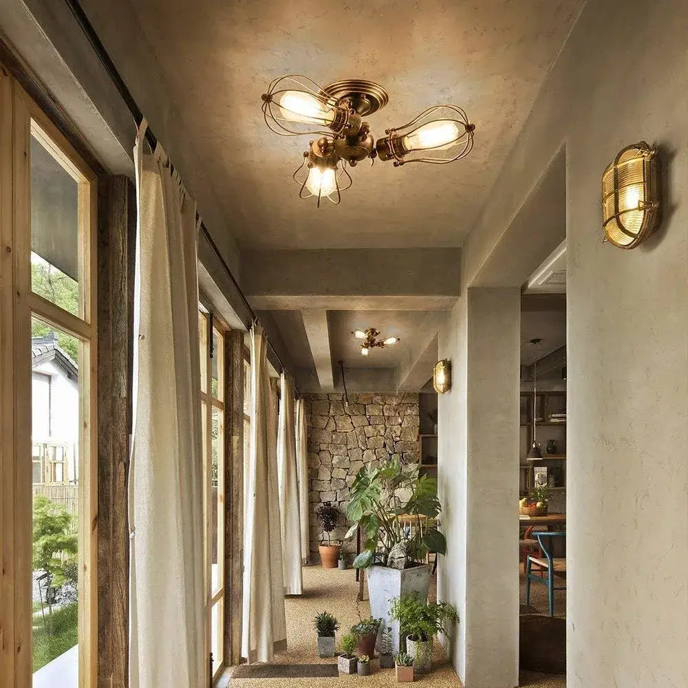 Brass decorbites industrial vintage ceiling light with exposed filament bulbs and black metal wire cage for dining room